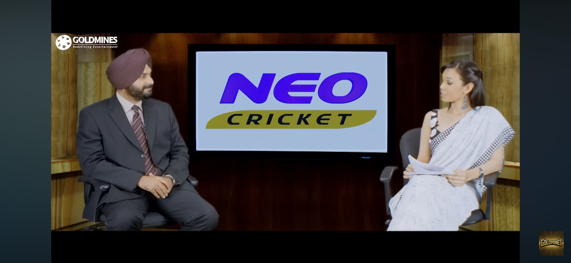 Nidhi Sharma interviewing a guest on a television set
